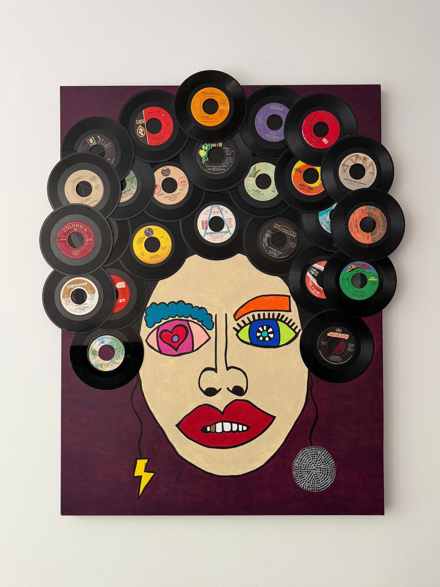 Portrait painting of a face with hair made from vinyl records on a deep purple background.